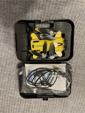 Compact Yellow Foldable Mini Drone with Remote Control and Carry Case